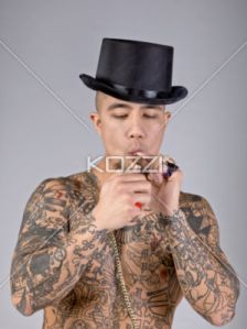 photo-24757468-shirtless-man-with-tattoo-and-hat-smoking